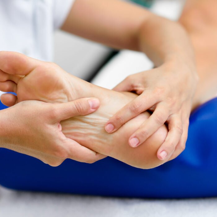 Medical massage at the foot in a physiotherapy center.